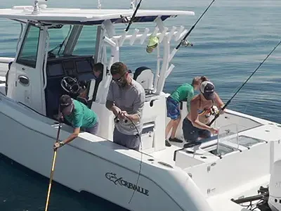 Image of a family fishing off of a Crevalle boat